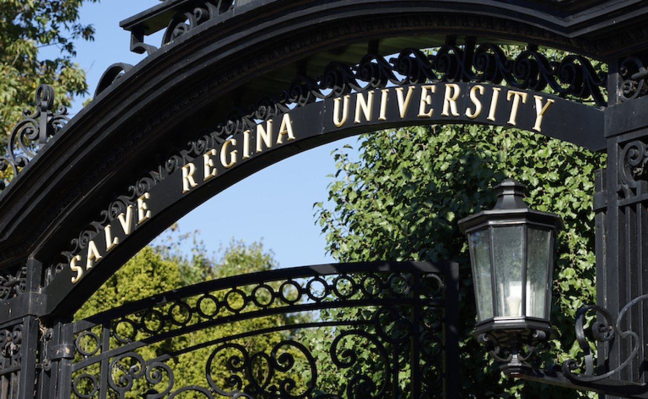 Close up of top of ochre court gates showing the words Salve Regina University
