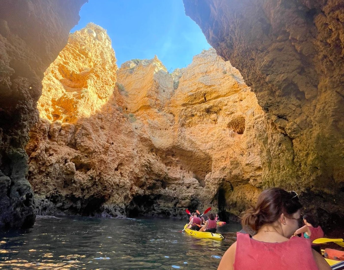 students kayaking out of caves