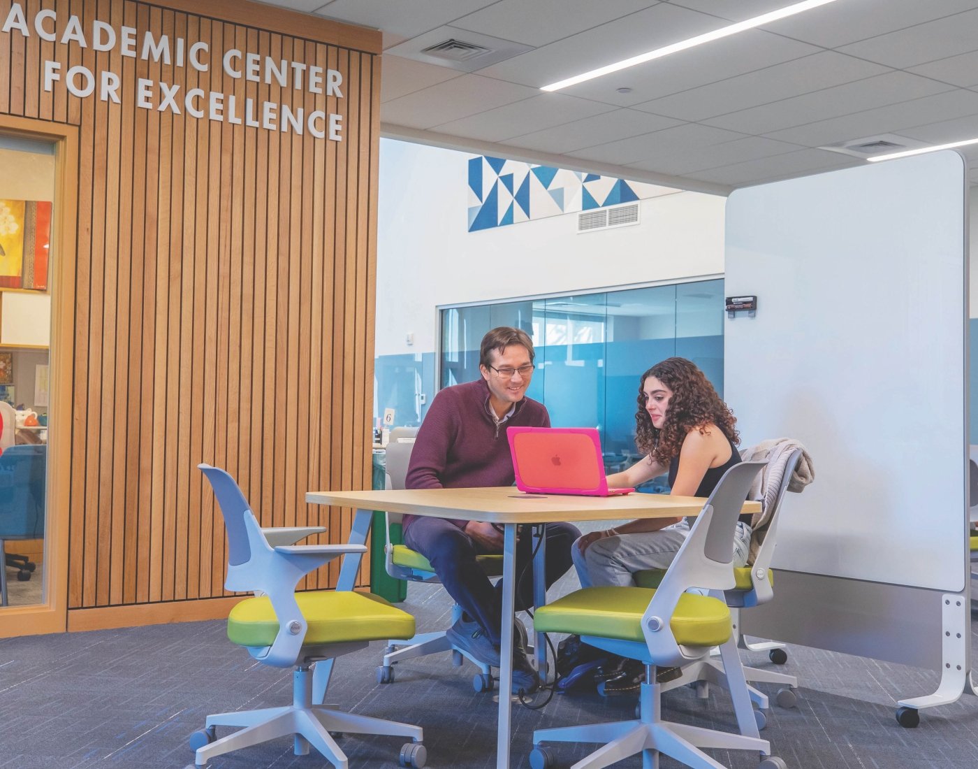 Compass advisor meeting with student in the academic center for excellence