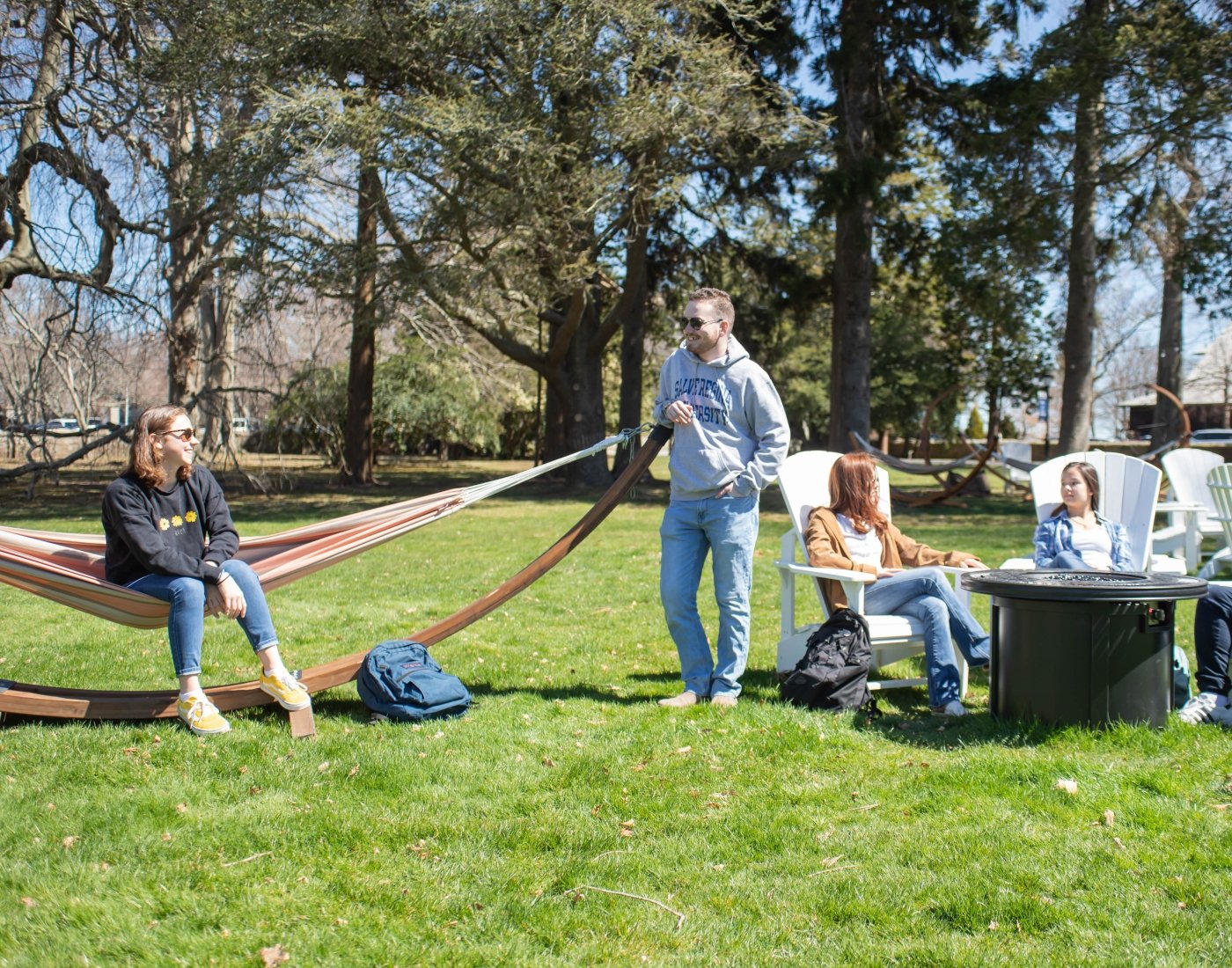 Students socializing outside in chairs