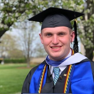 Salve master's in criminal justice and cybersecurity graduate in cap and gown