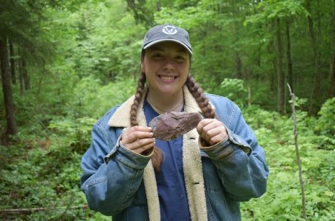 student holding artifact