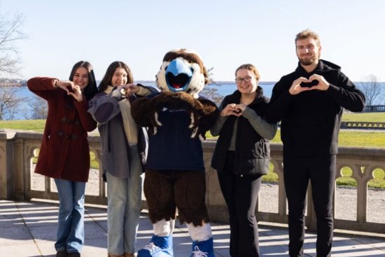A group of people making hearts with their hands