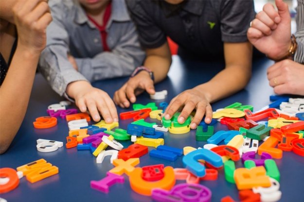 children playing with plastic letters