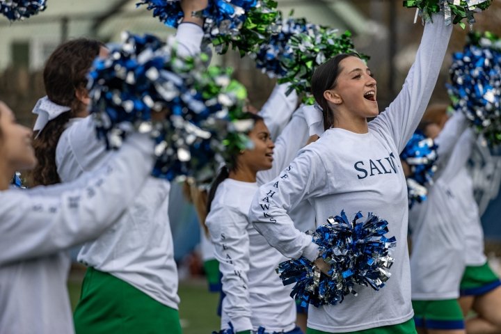 Cheerleaders with pompoms at a football game