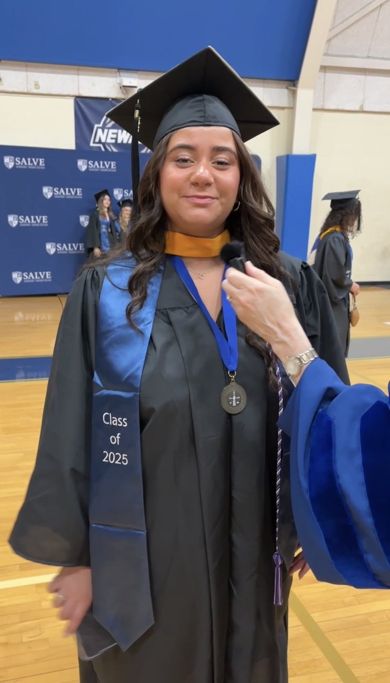 A woman wearing a graduation cap and gown