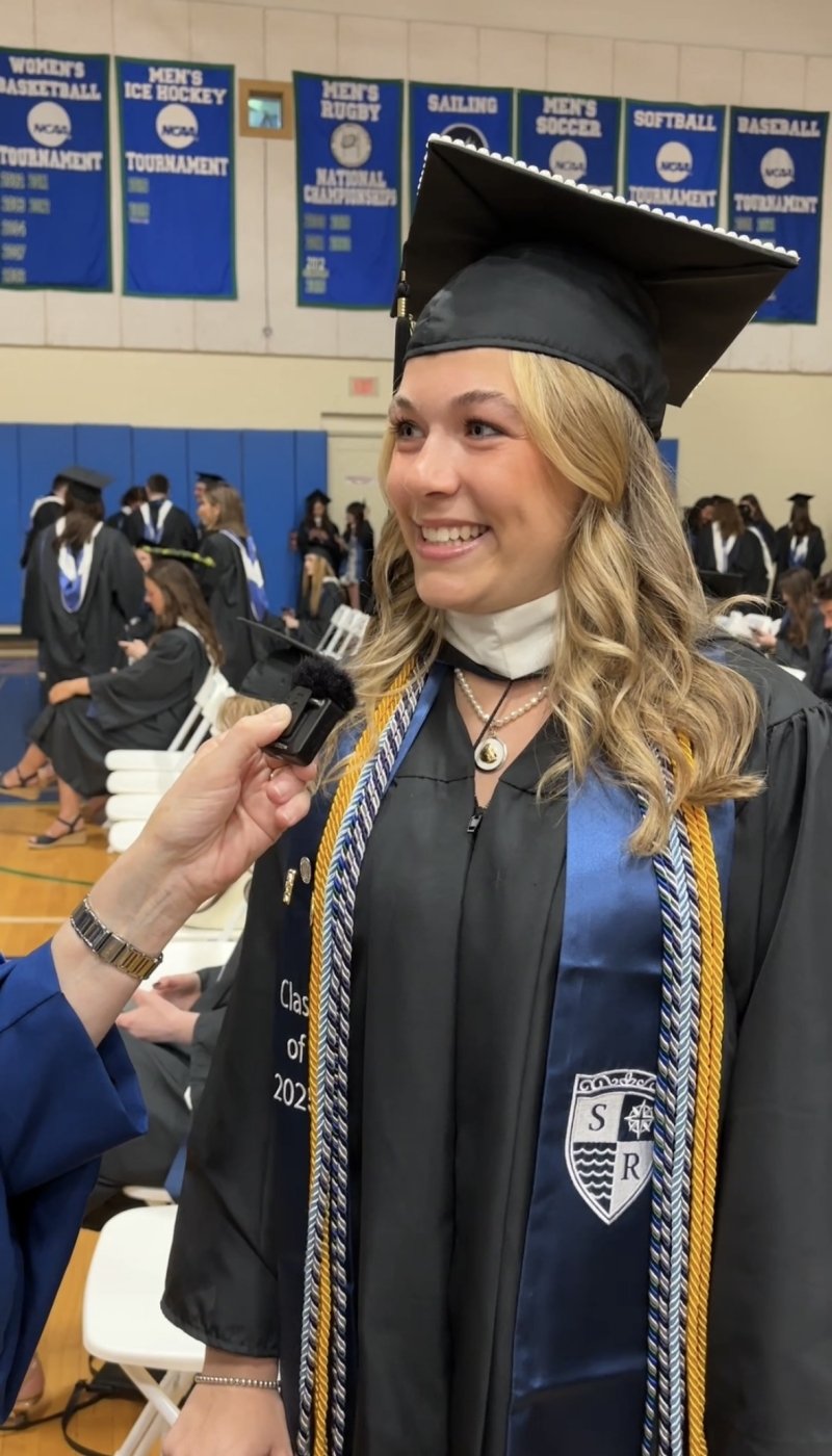 A woman wearing a graduation cap and gown